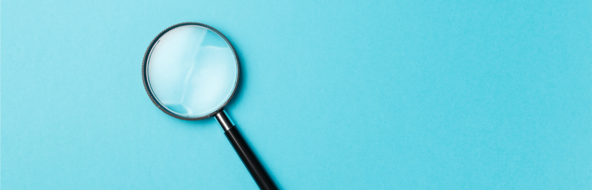 Magnifying glass on light blue background
