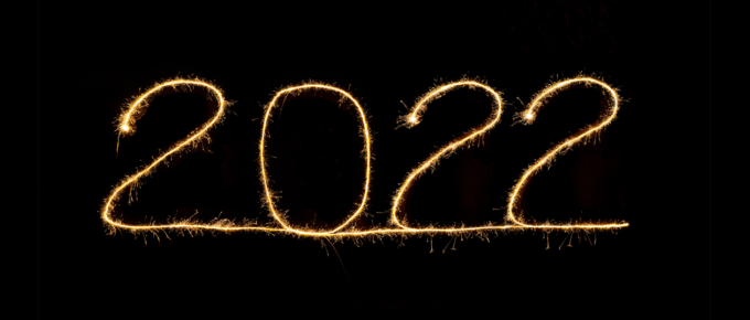 The numbers 2022 written in sparklers on a black background