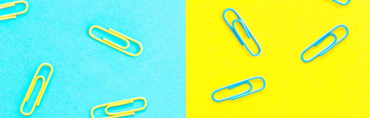 Paperclips on a bright blue and yellow background