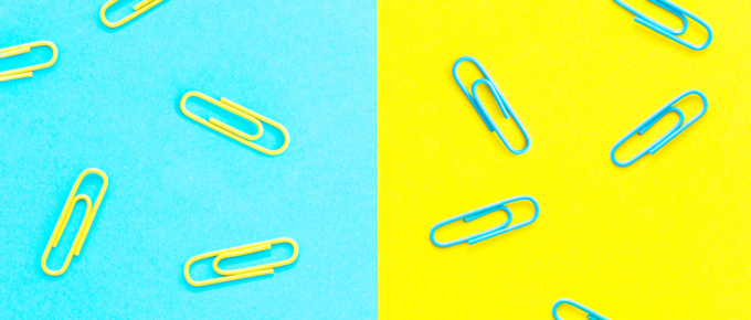 Paperclips on a bright blue and yellow background