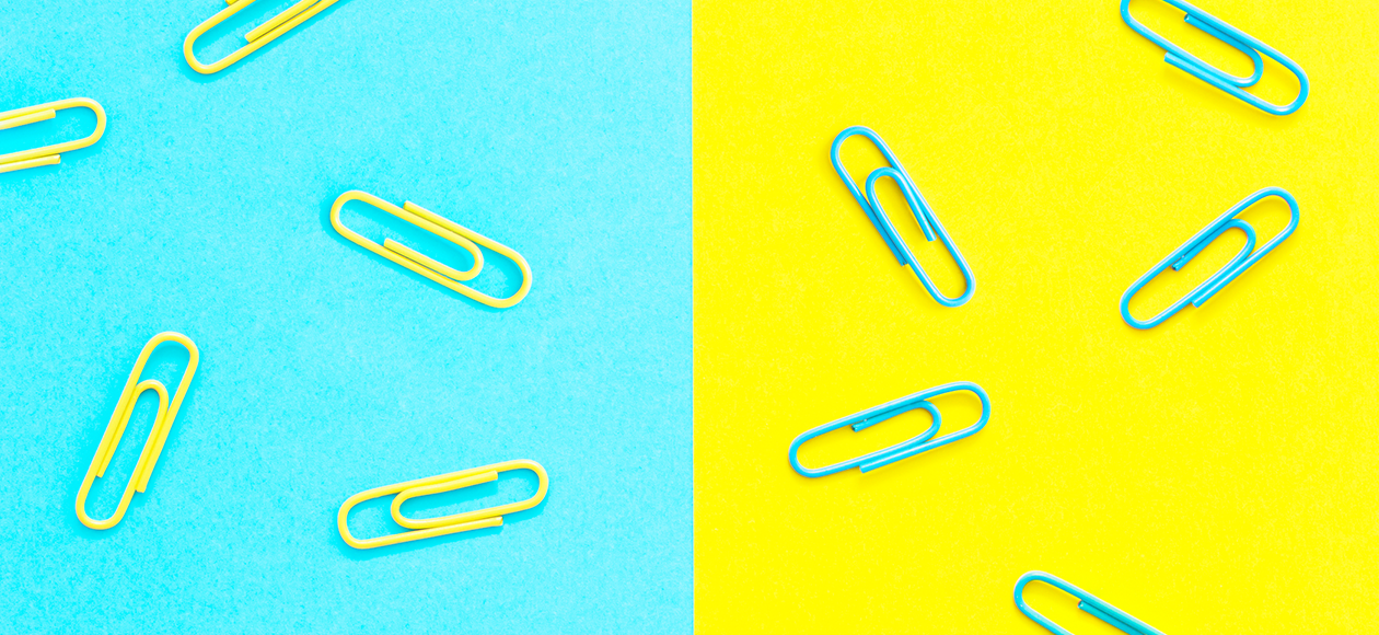 Paperclips on a bright blue and yellow background