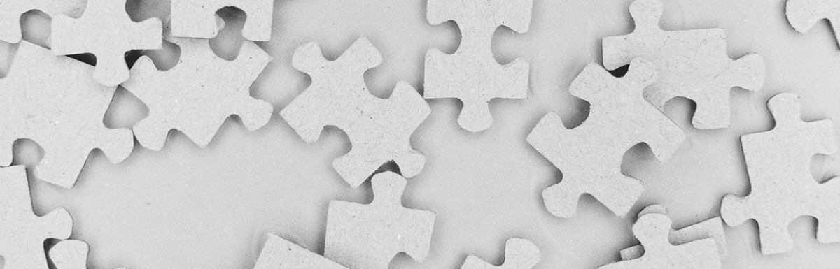 Scattered white puzzle pieces